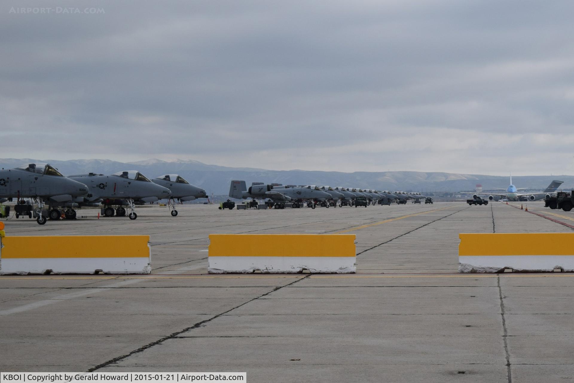 Boise Air Terminal/gowen Fld Airport (BOI) - Idaho ANG's A-10C are all parked with their guns facing away from the runways. Note Air Force One in background. A-10s are normally parked facing the runways. Secret Service didn't trust them.