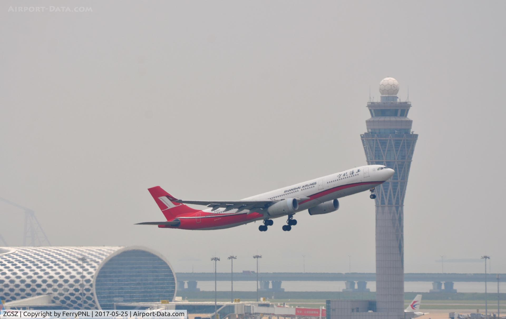 Shenzhen Bao'an International Airport, Shenzhen, Guangdong China (ZGSZ) - Shanghai A333 lifting of in front of Shenzhen Airport tower.