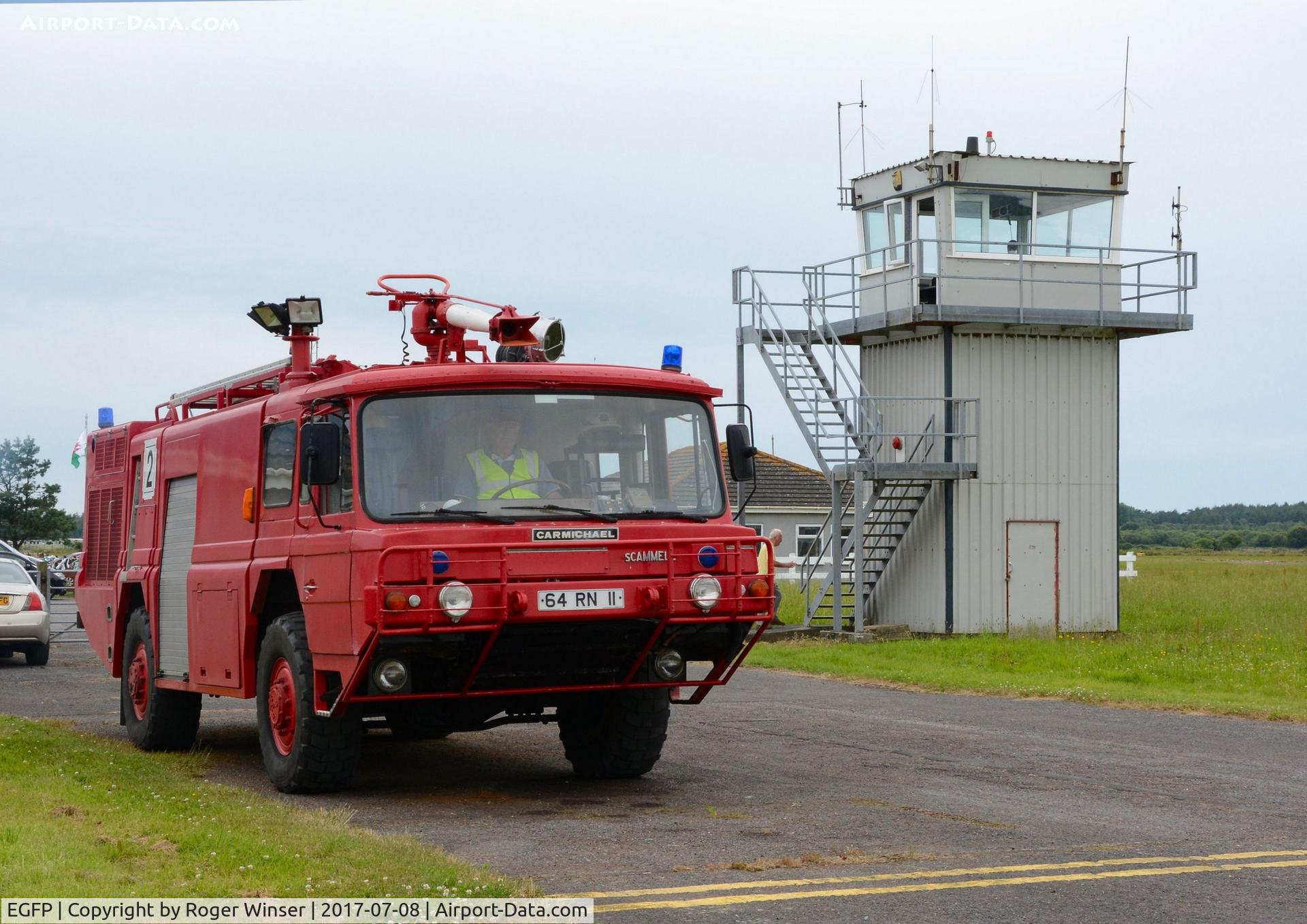 Pembrey Airport, Pembrey, Wales United Kingdom (EGFP) - Former Royal Navy fire and rescue tender 'Fire 2' by the airport's control tower 