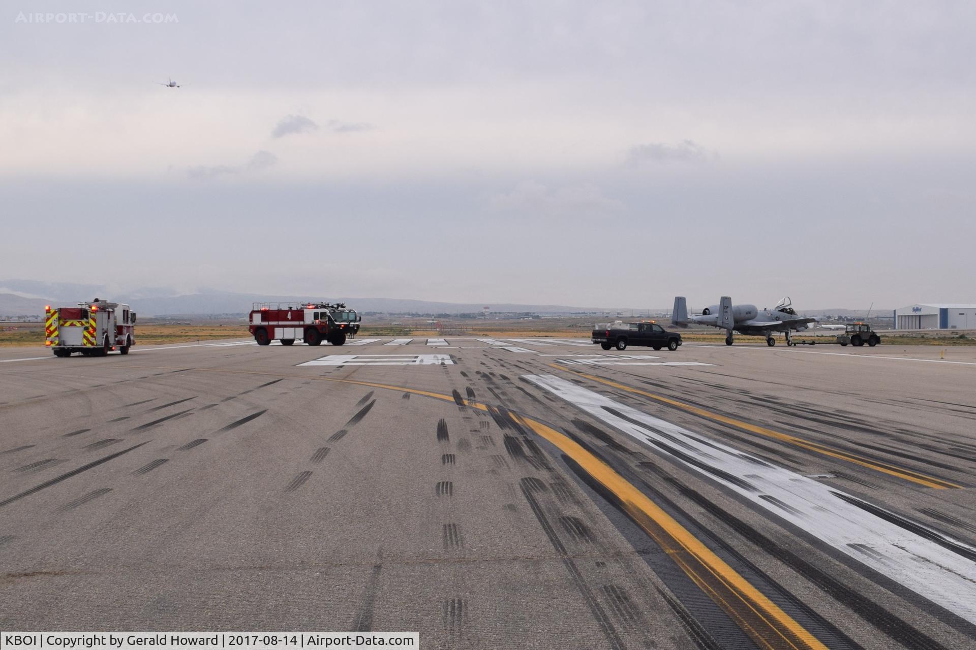 Boise Air Terminal/gowen Fld Airport (BOI) - Disabled A-10 being towed off runway followed by emergency equipment.
