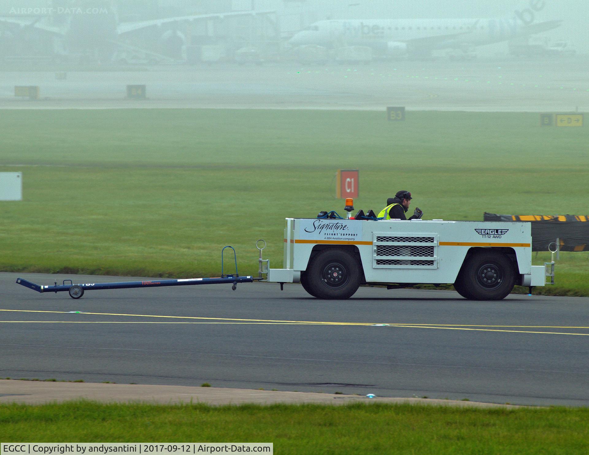 Manchester Airport, Manchester, England United Kingdom (EGCC) - FBO tug going to get [D-BUZZ CE750] and tow it over to the [FBO exc ramp] at egcc uk.