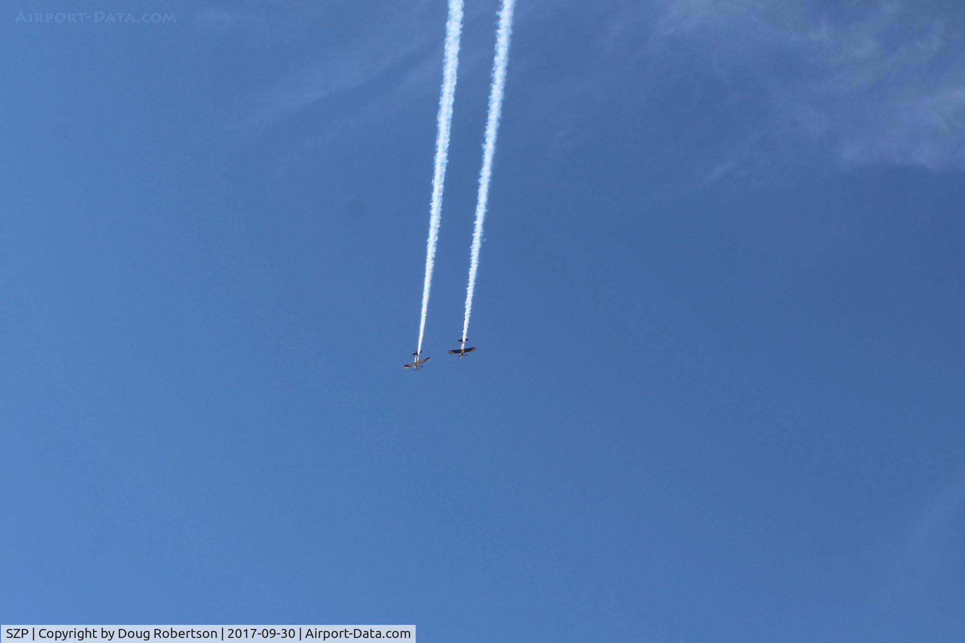 Santa Paula Airport (SZP) - N144X and N145HR doing a high near synonymous fast razzle dazzle with smoke high overhead arrival to SZP before landing. 