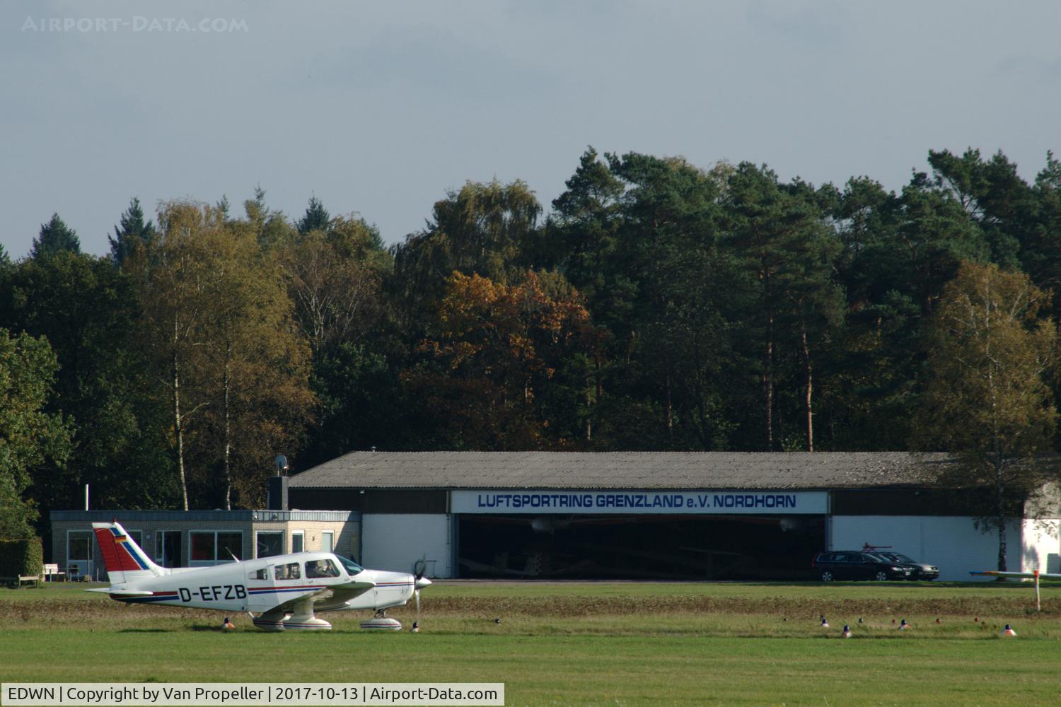 EDWN Airport - Hangar of Luftsportring Grenzland e.V. Nordhorn at Klausheide (Nordhorn-Lingen) airfield, Germany. Piper PA-28-161 Warrior II D-EFZB of VfM is preparing for take off.