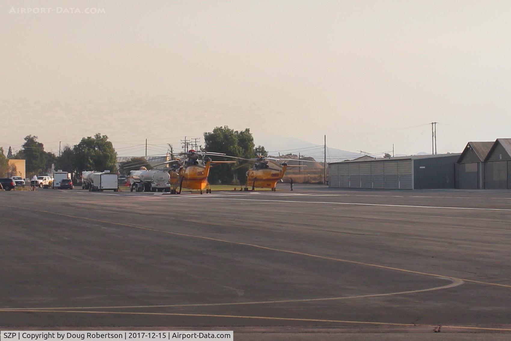 Santa Paula Airport (SZP) - Two Fire Bombers in support of the Thomas Fire suppression. Rwy 04-22 overtaken by many such helicopters. Smoky skies from the fire.