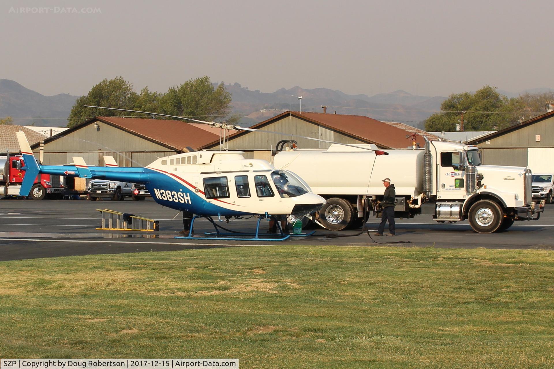 Santa Paula Airport (SZP) - N383SH 1983 Bell 206L-3 LongRanger III, Allison 250-C30P turboshaft 650 SHp, being serviced at SZP Thomas Fire FireBase. Note smoky sky.