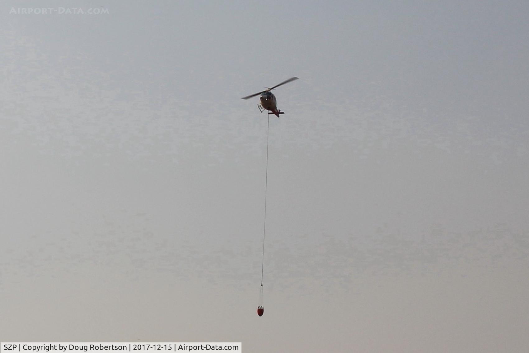Santa Paula Airport (SZP) - Firebomber returning to SZP Thomas Fire Firebase with dumped sling load. Please view large.