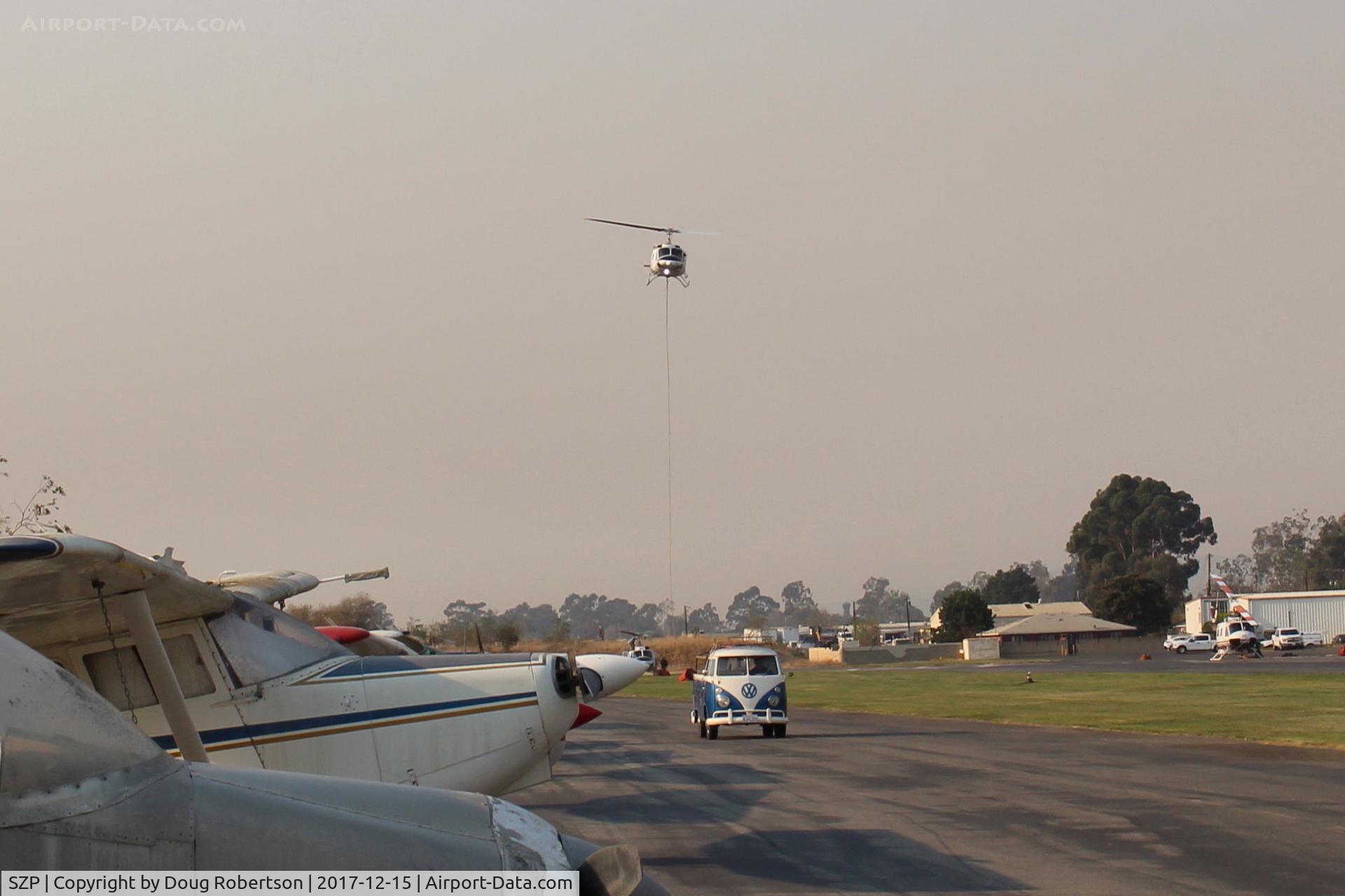 Santa Paula Airport (SZP) - Returning Helicopter Firebomber to SZP Thomas Fire Firebase with emptied retardant chemical. The Firebomber helos are using most all space at SZP. SZP closed to General Aviation flights.