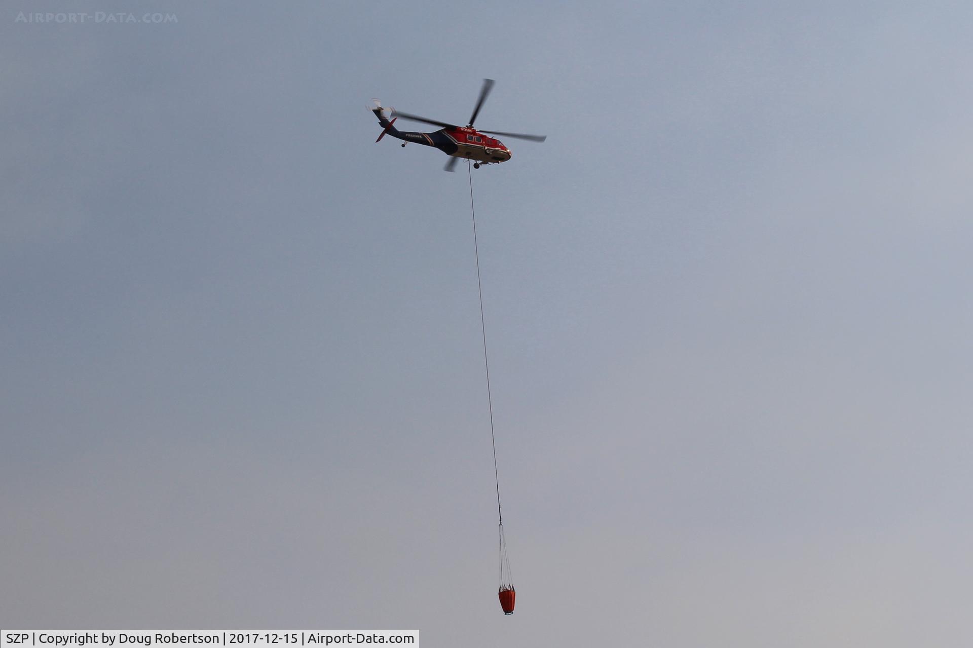 Santa Paula Airport (SZP) - N135BH 1987 Sikorsky S-70A-27 FIREHAWK, GE-T700 series, Restricted class, departing SZP Firebase with Phos-Chek retardant hopper in sling to Thomas Fire drop