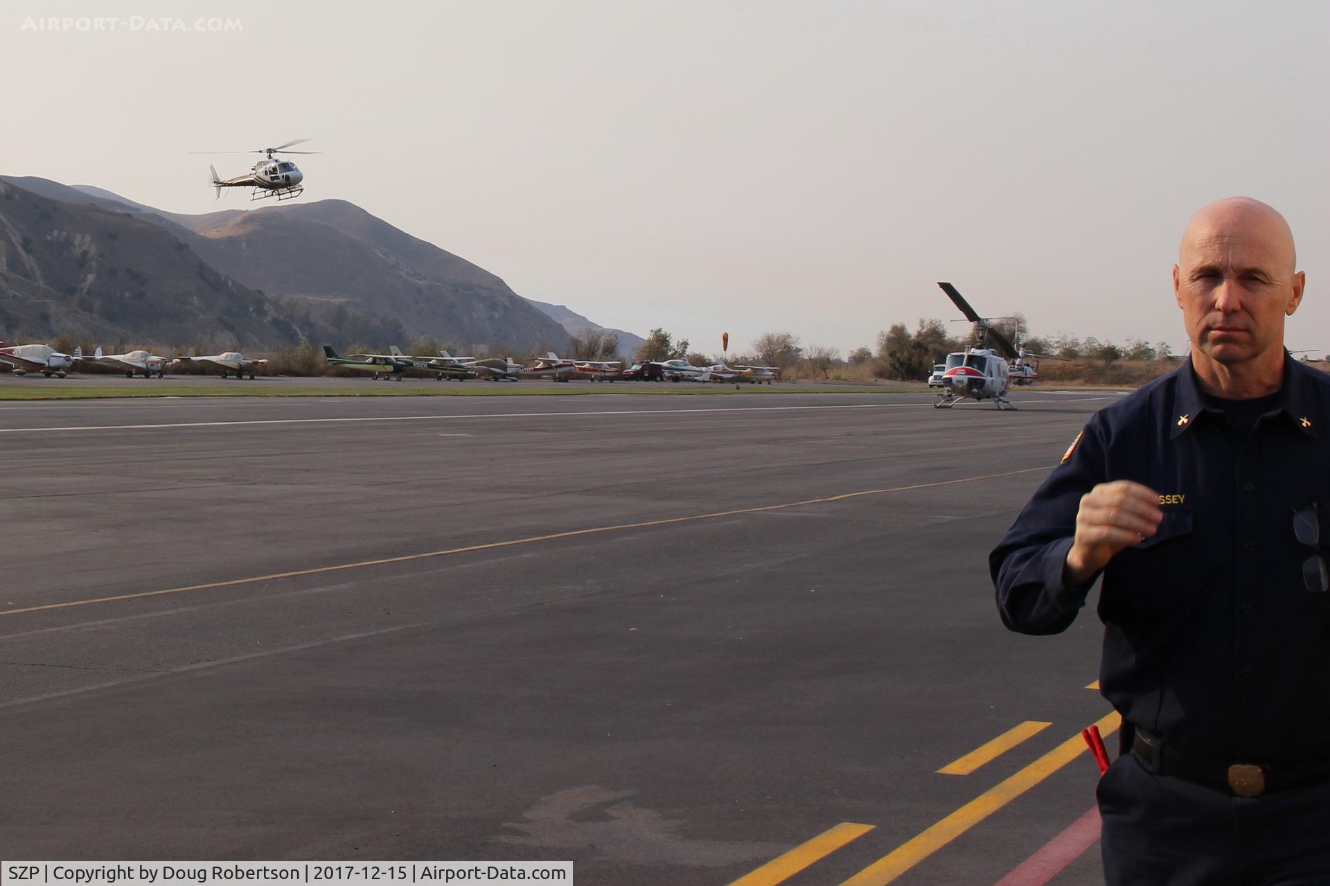 Santa Paula Airport (SZP) - Firebombers landing and landed at the SZP FireBase for the Thomas Fire suppression efforts,  and a Fireman entering the photo. Thank You for all your efforts!