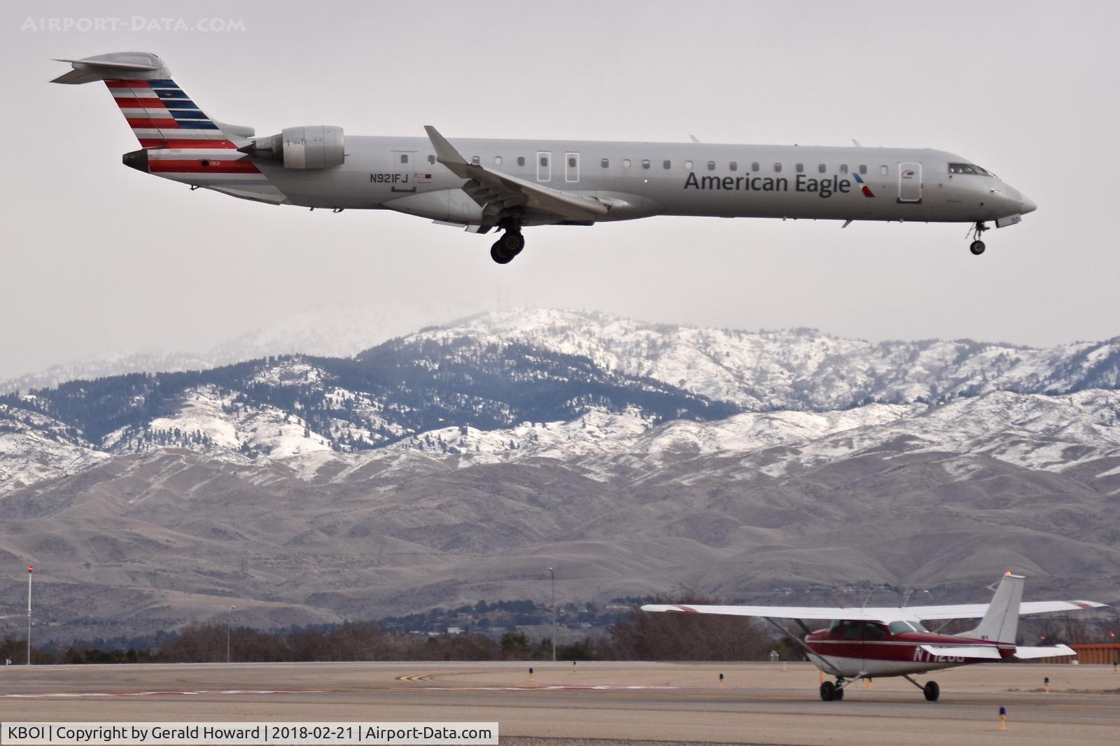 Boise Air Terminal/gowen Fld Airport (BOI) - American landing RWY 10R while the Cessna waits and the snows move closer.