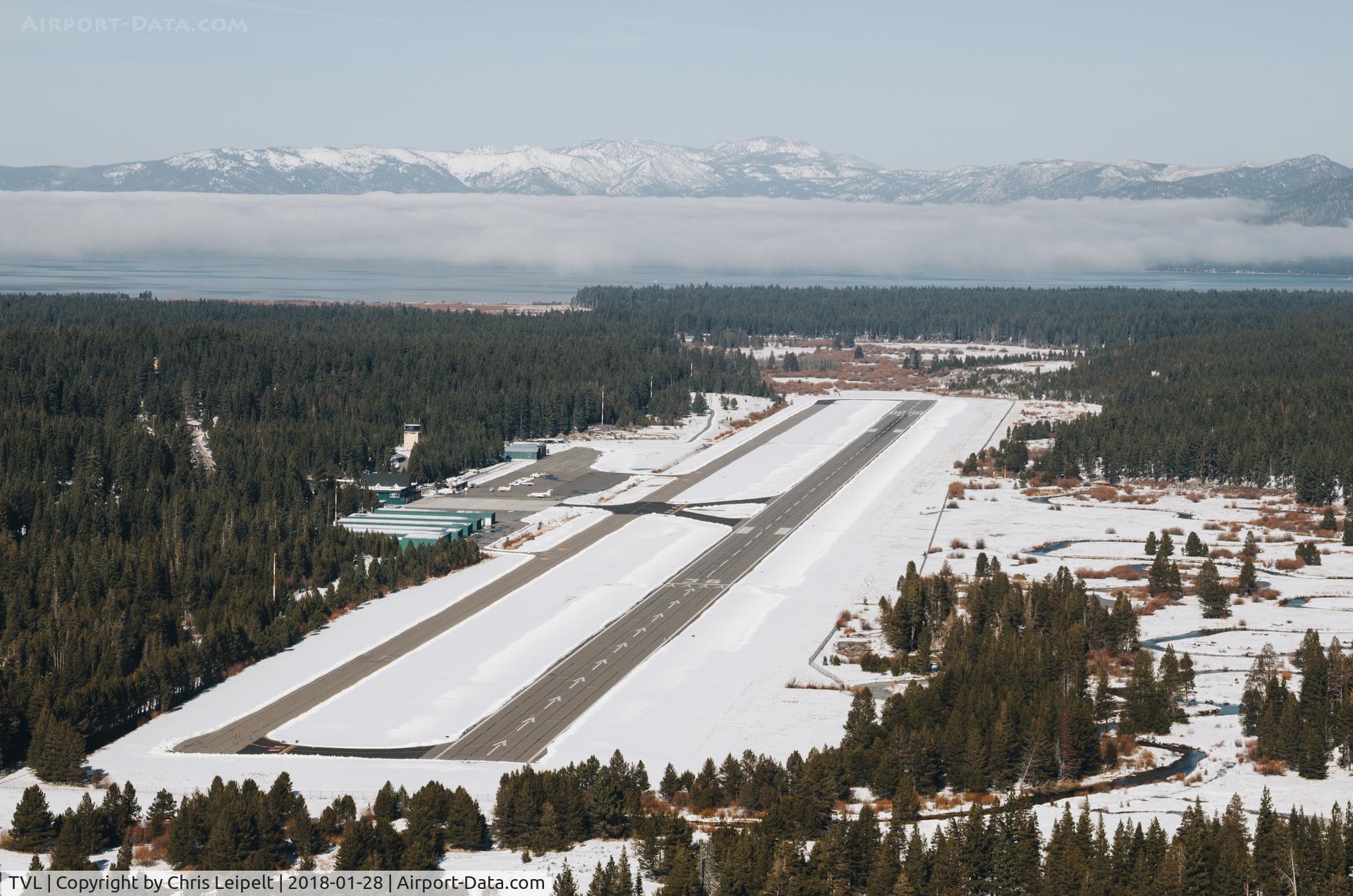Lake Tahoe Airport (TVL) - South Lake Tahoe Airport facing NW with Lake Tahoe covered by fog just ahead of the airport.