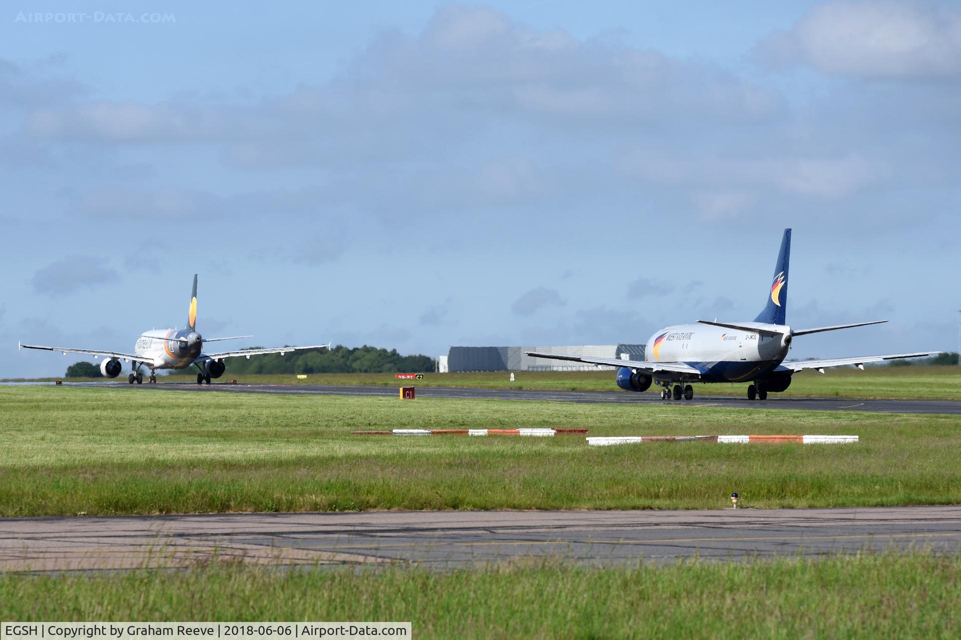 Norwich International Airport, Norwich, England United Kingdom (EGSH) - YL-LCO and G-JMCS both on taxiway Charlie.