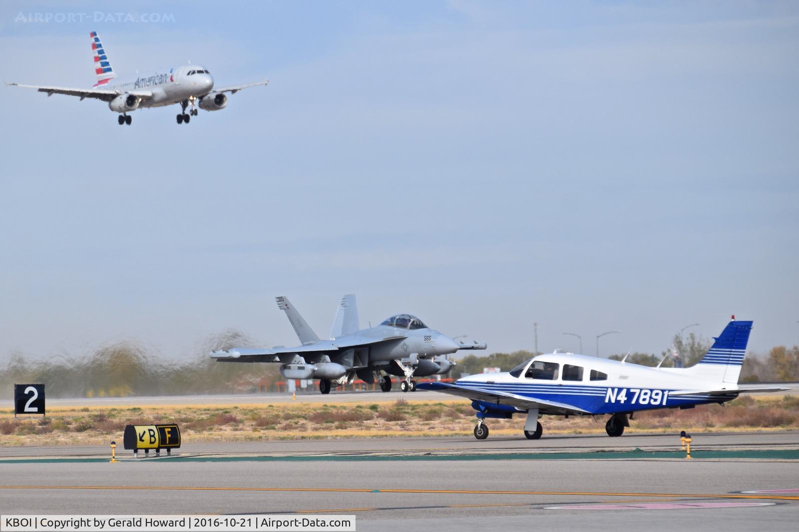 Boise Air Terminal/gowen Fld Airport (BOI) - A Piper on Taxiway Foxtrot while an EA-18G takes off on RWY 10R and American Airlines lands on RWY 10L.