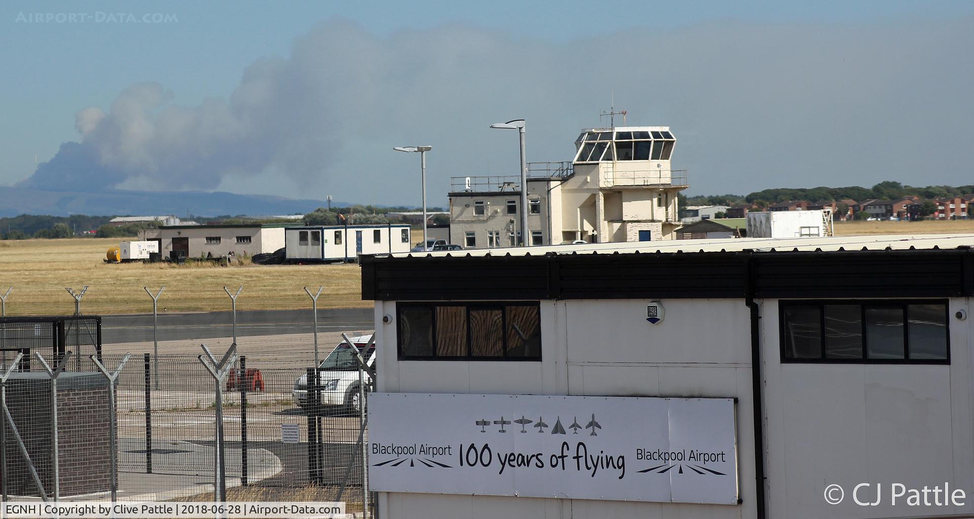 Blackpool International Airport, Blackpool, England United Kingdom (EGNH) - Airfield view at Blackpool. In the background a wild moorland fire at Stalybridge dominates the skyline.