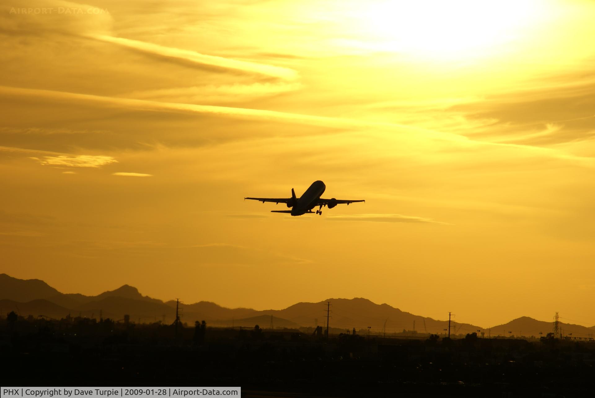 Phoenix Sky Harbor International Airport (PHX) - A takeoff into an amazing Arizona sunset.  This picture is not adjusted; this is the way the sky really looked.