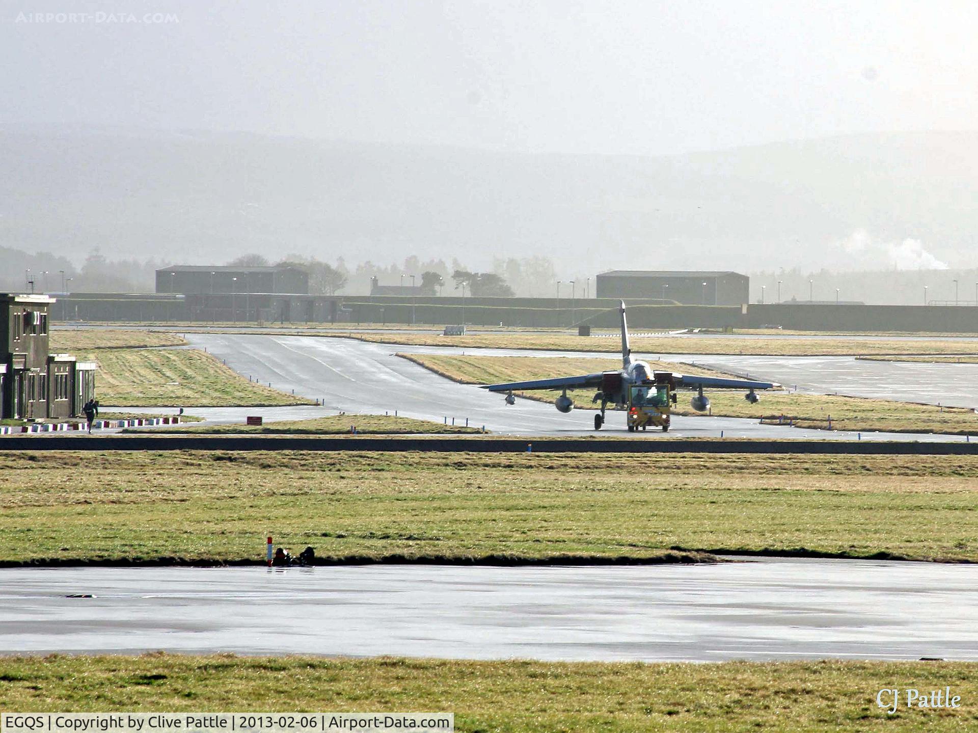 RAF Lossiemouth Airport, Lossiemouth, Scotland United Kingdom (EGQS) - The sunshine after the rain - A Tornado GR4 is towed across the airfield