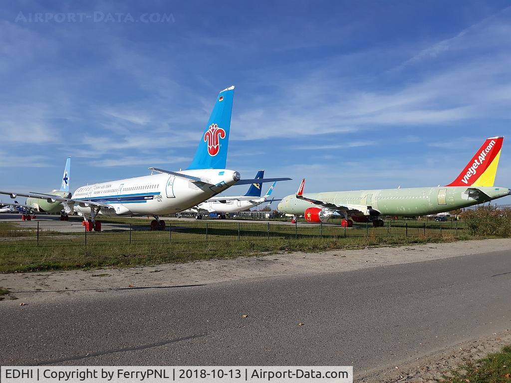 Hamburg Finkenwerder Airport, Hamburg Germany (EDHI) - Planes stowed away in a corner for future delivery to their customers.