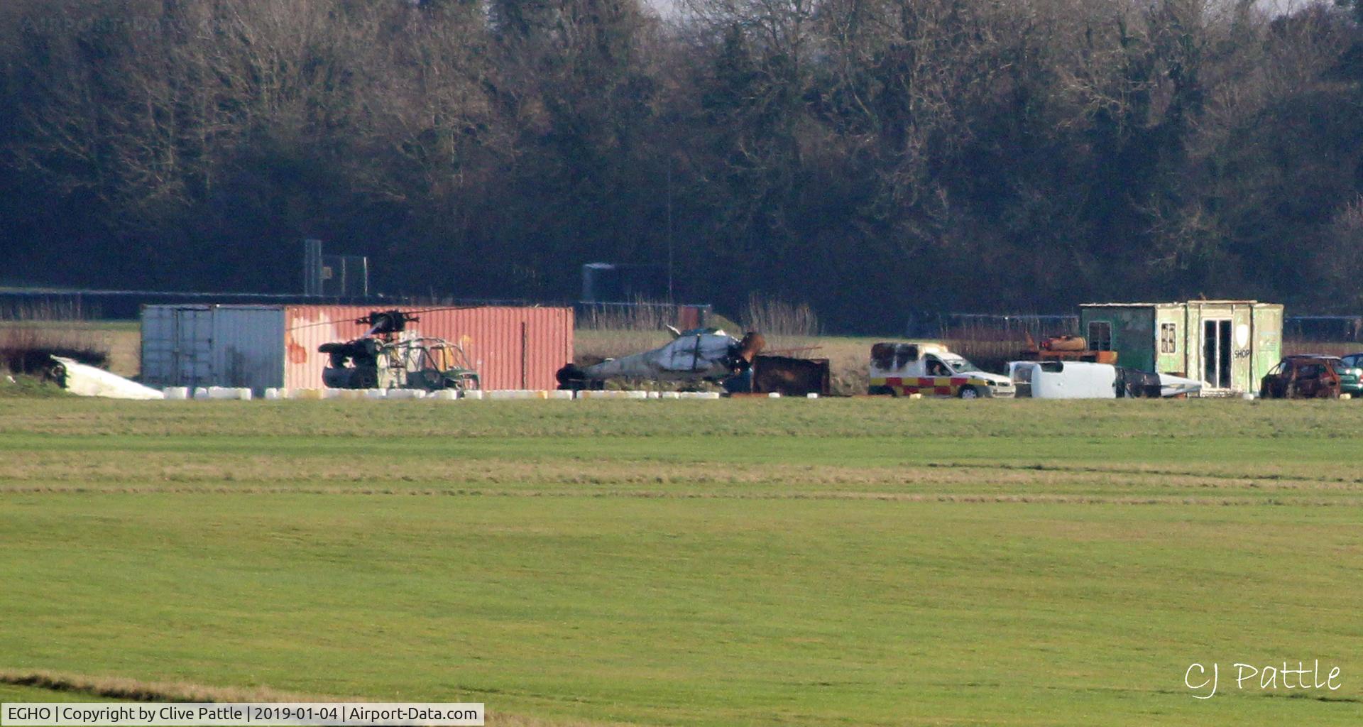 Thruxton Aerodrome Airport, Andover, England United Kingdom (EGHO) - Long distance view of the airfield dump at Thruxton - on the south side - showing the hulks of three unidentified helicopters, including a Westland Scout AH.1 airframe.