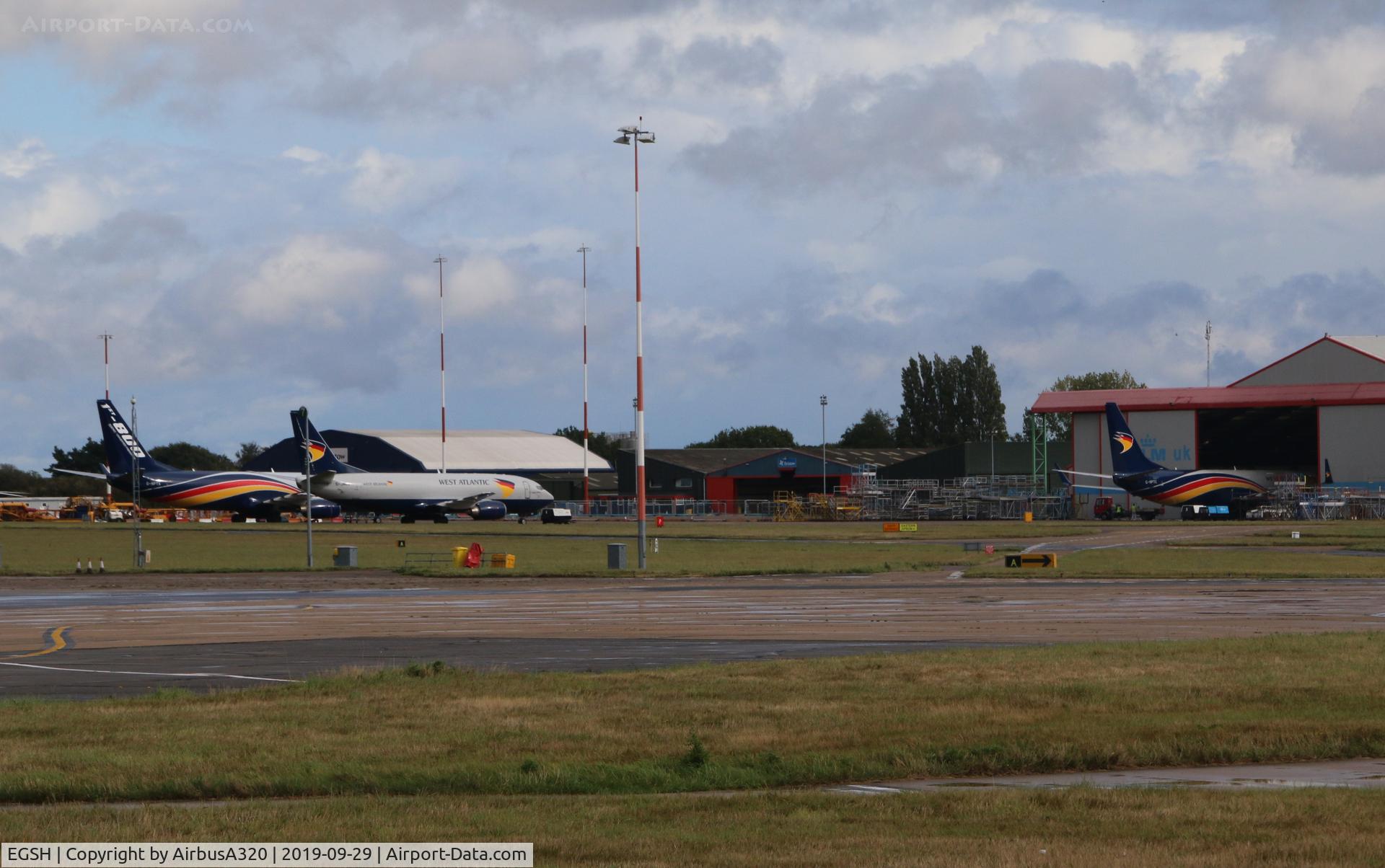 Norwich International Airport, Norwich, England United Kingdom (EGSH) - West Atlantic fleet gather at Norwich
737-800s G-NPTA & G-NPTC (Nose in hangar) joined with a 737-400 G-JMCU