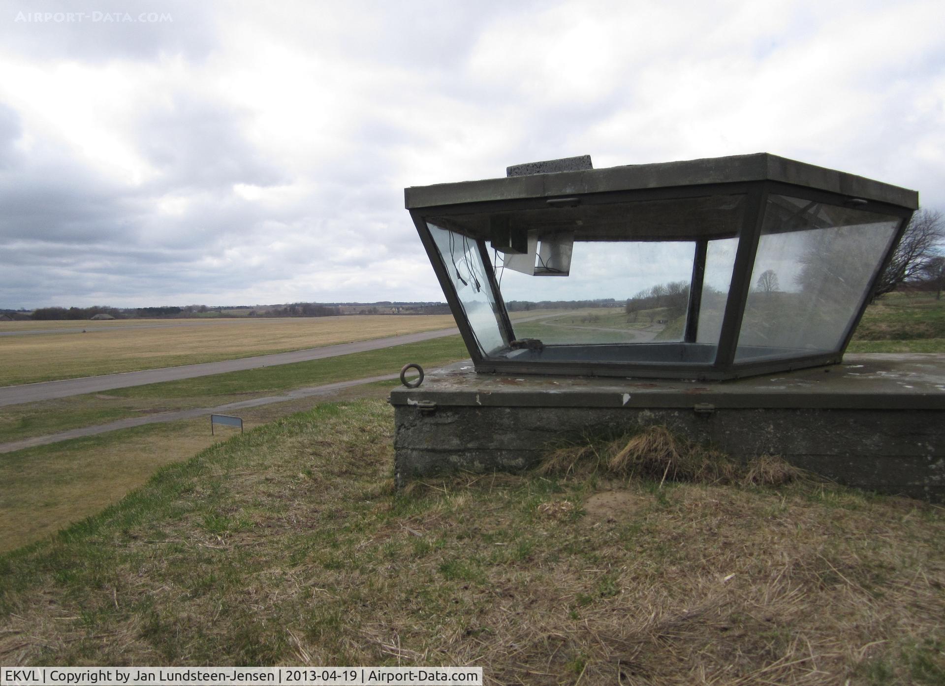 EKVL Airport - The spare control tower at Vaerloese Air Base in Denmark. The tower was built in 1961 and is partly buried in the sloping terrain north of the runway and taxiway.