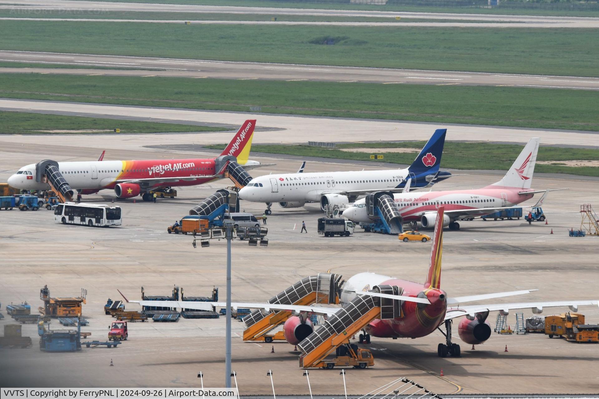 Tan Son Nhat International Airport, Ho Chi Minh City Viet Nam (VVTS) - Planes being handled on the tarmac in SGN