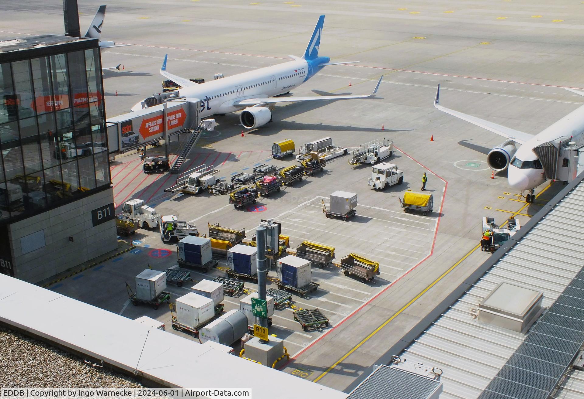 Berlin Brandenburg International Airport, Berlin Germany (EDDB) - apron, service vehicles and boarding bridge at BER airport