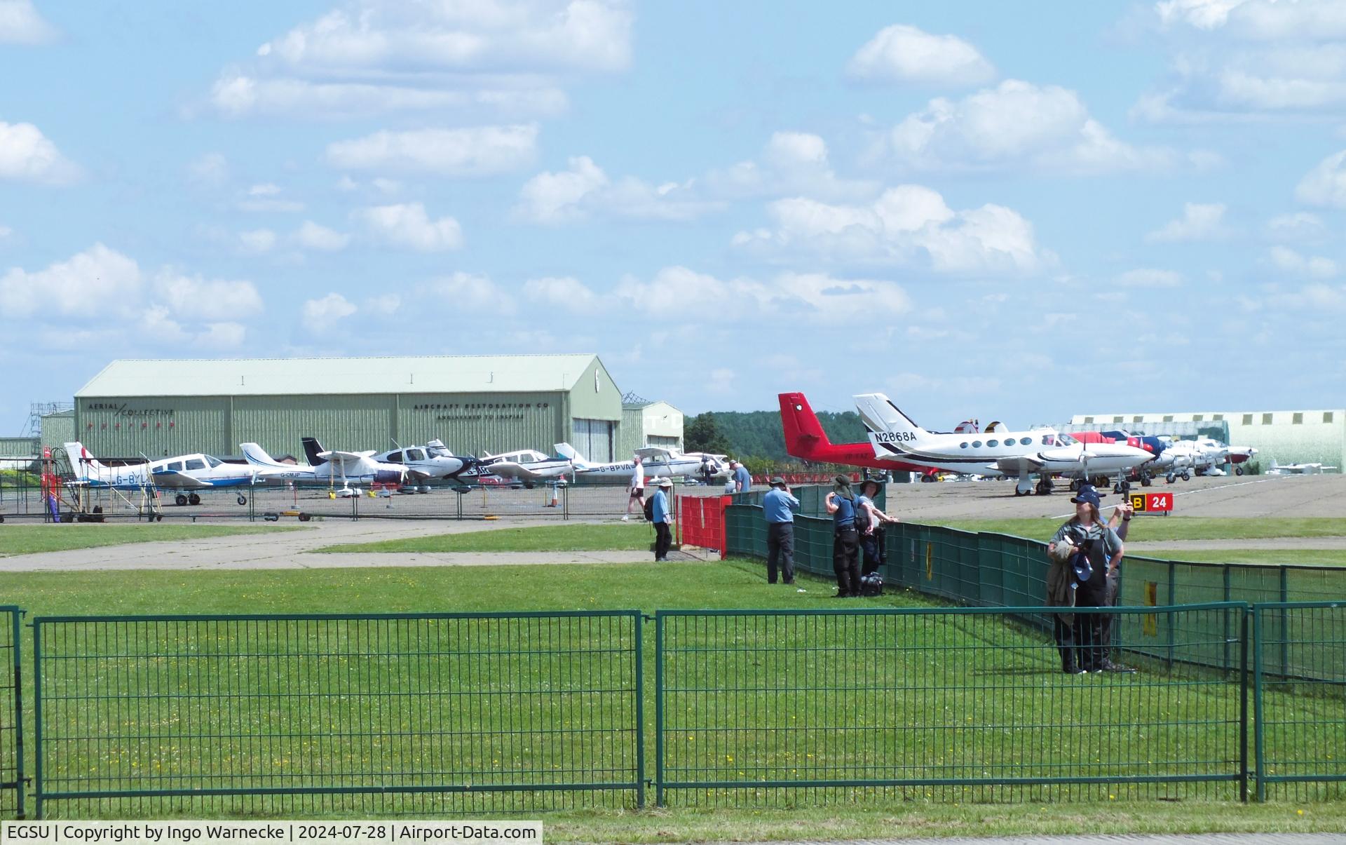 Duxford Airport, Cambridge, England United Kingdom (EGSU) - parked aircraft on apron and museum hangars at Duxford airfield