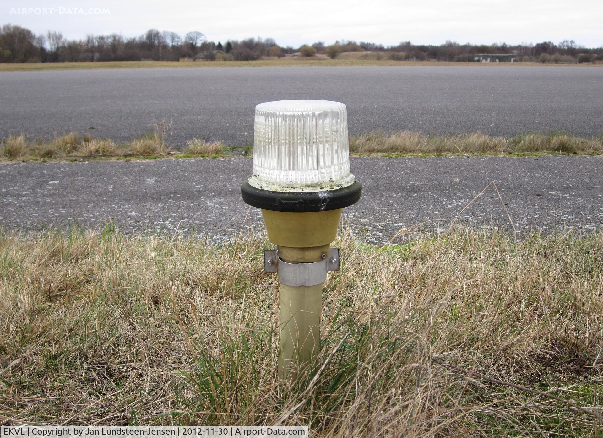 EKVL Airport - Runway edge light at the abandoned Vaerloese Air Base in Denmark in 2012. The light was removed a few months later.