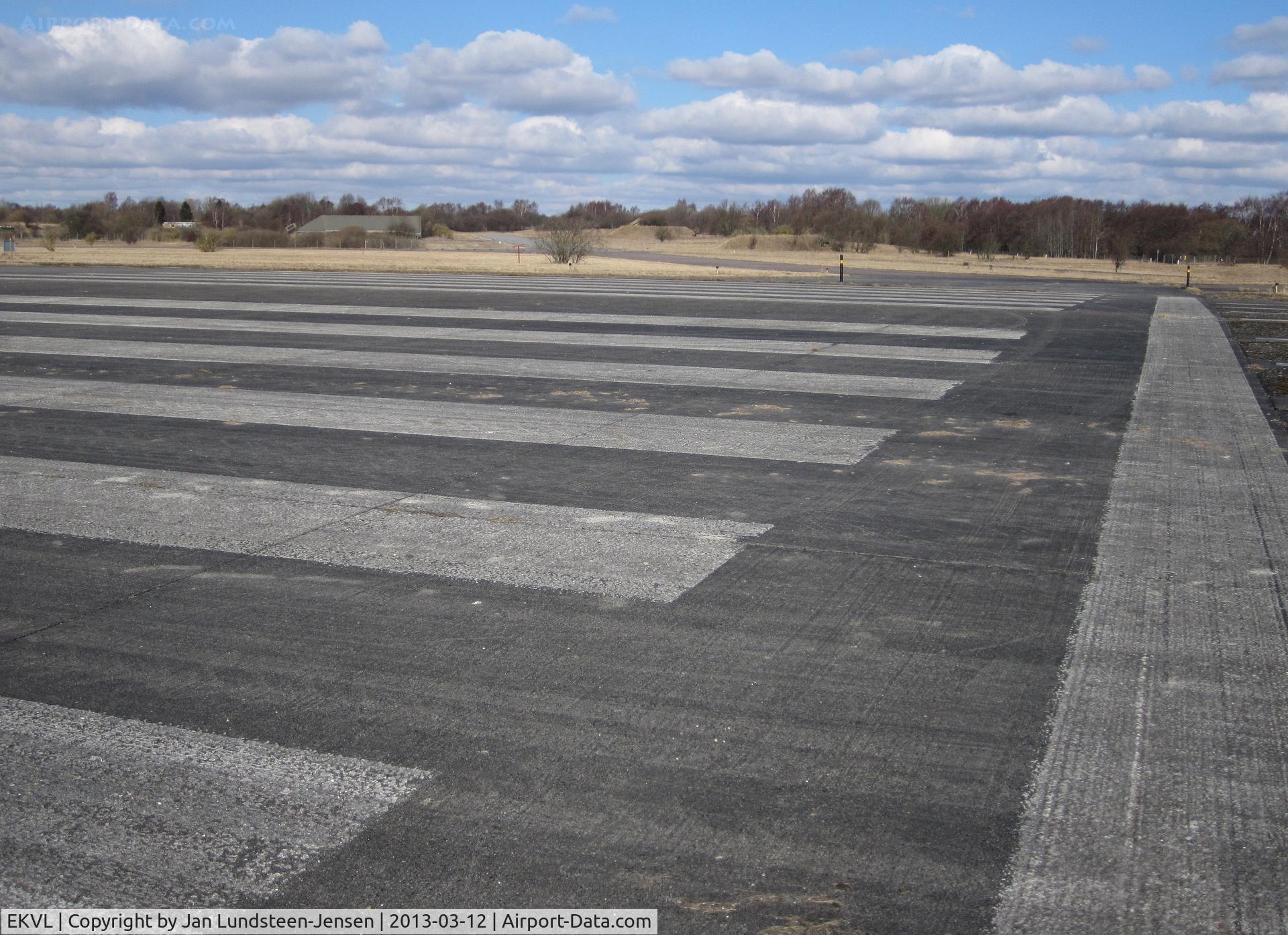 EKVL Airport - Runway 28 threshold at the closed Vaerloese Air Base in Denmark. The runway was built in 1952-1953. The air base closed in 2004. Since October 2013 the airfield has been used occasionally for airshows.