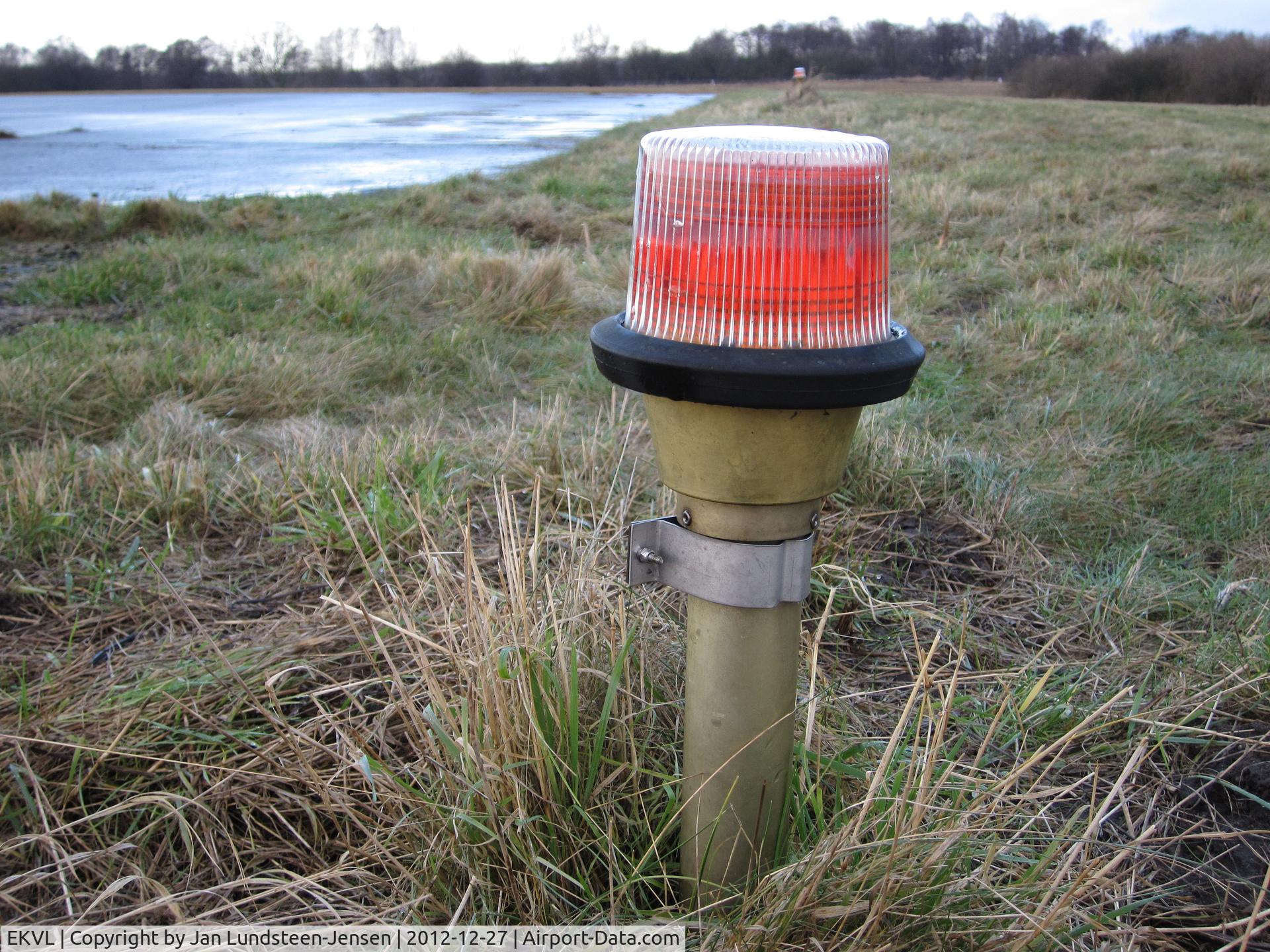 EKVL Airport - One of the red lights at the pre-threshold area of Runway 28 at the closed Vaerloese Air Base in Denmark. The lights were removed some months later.