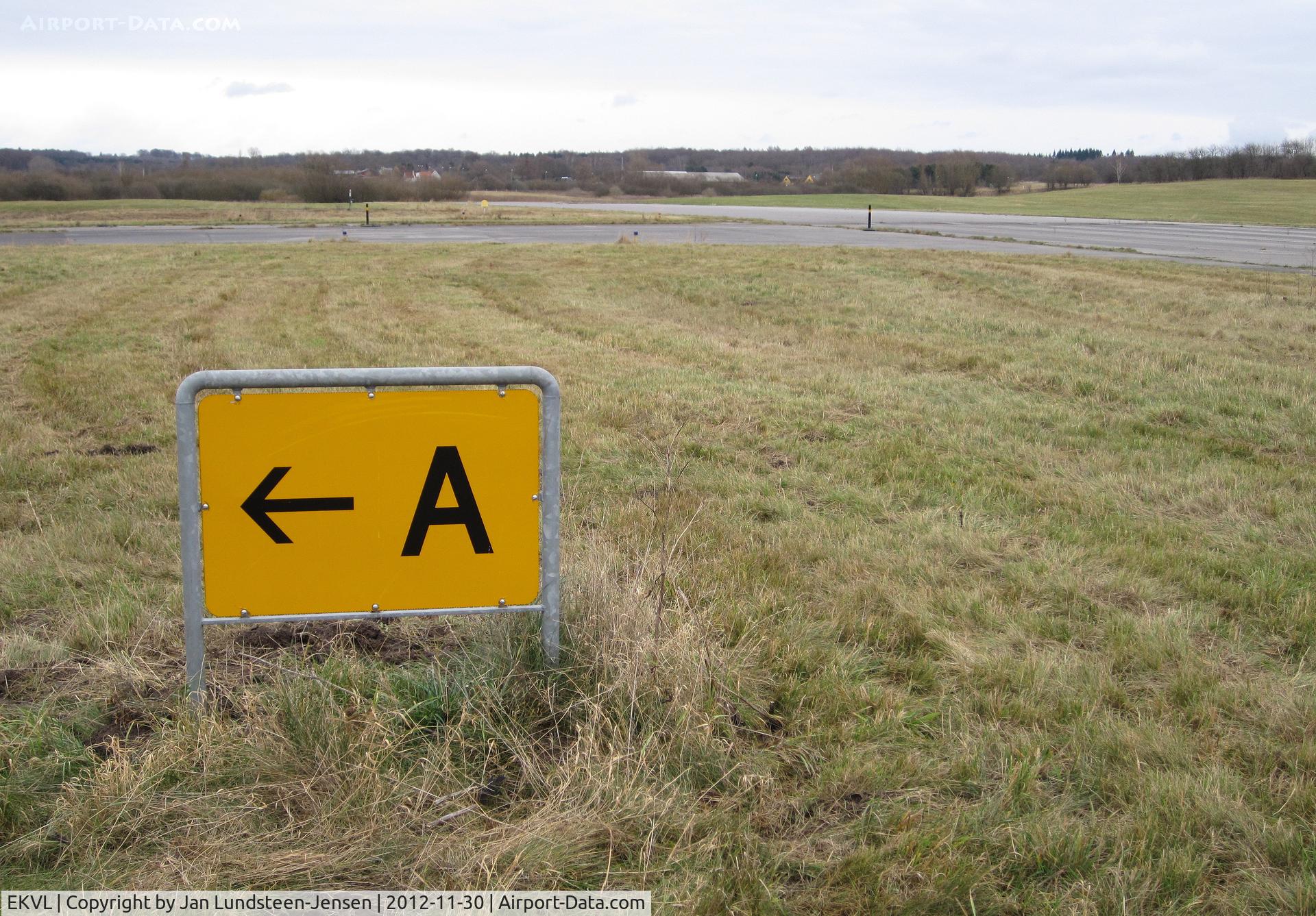 EKVL Airport - Taxiway Alpha runway exit sign at Runway 10 in the eastern part of the closed Vaerloese Air Base in Denmark. The sign was removed some months later.
