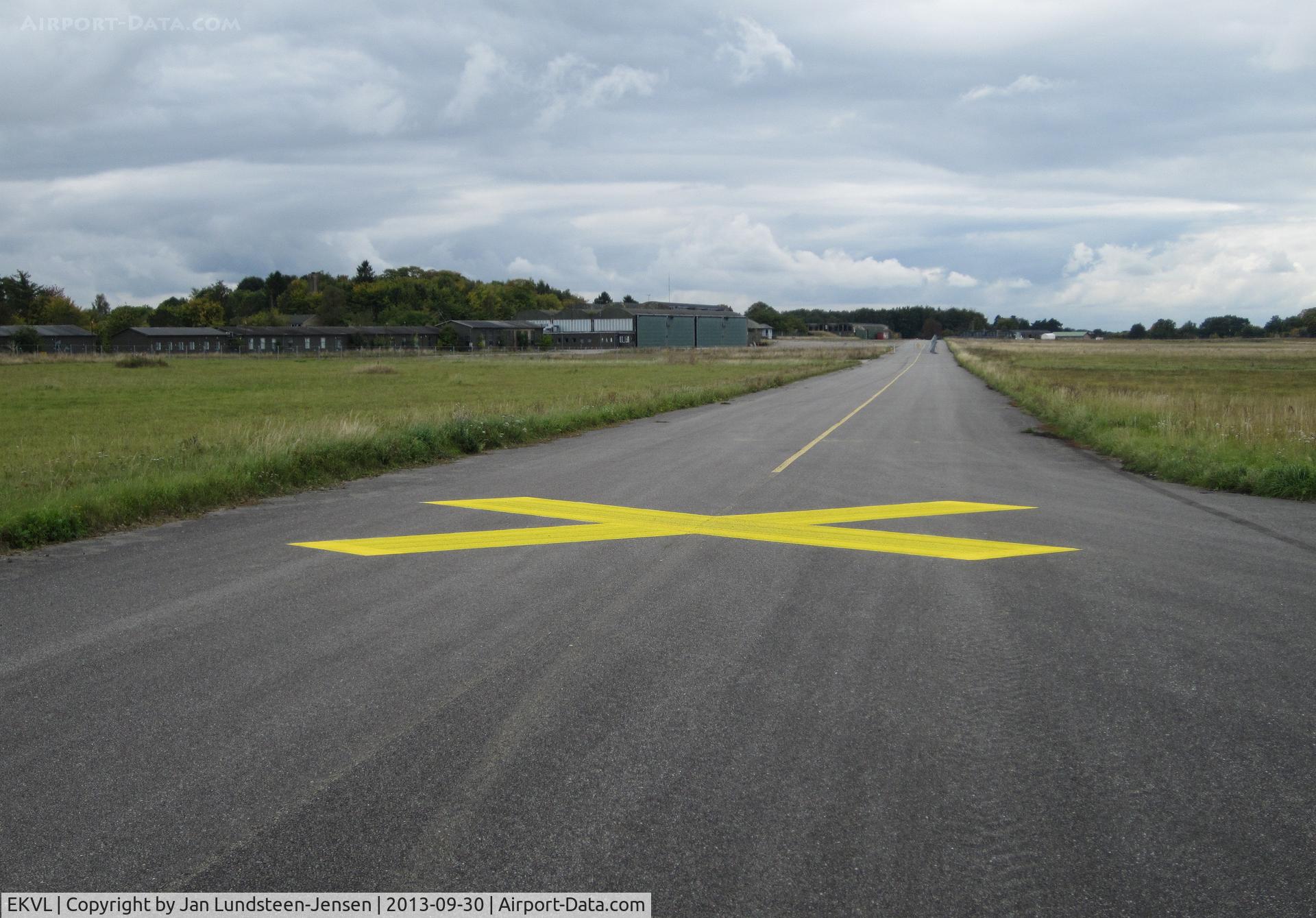 EKVL Airport - Taxiway Charlie South at the closed Vaerloese Air Base in Denmark. Yellow crosses were painted on the taxiways shortly before the air base became a civilian area. Photo taken on last day as a military territory.