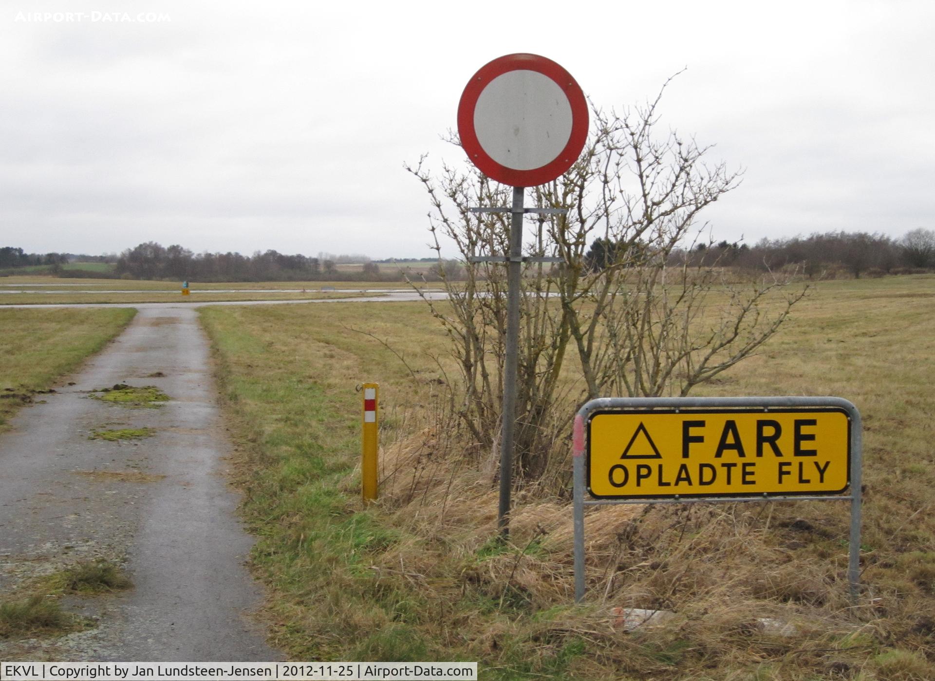 EKVL Airport - DANGER Armed Aircraft-sign in the north-western part of the closed Vaerloese Air Base in Denmark. The sign was later removed.