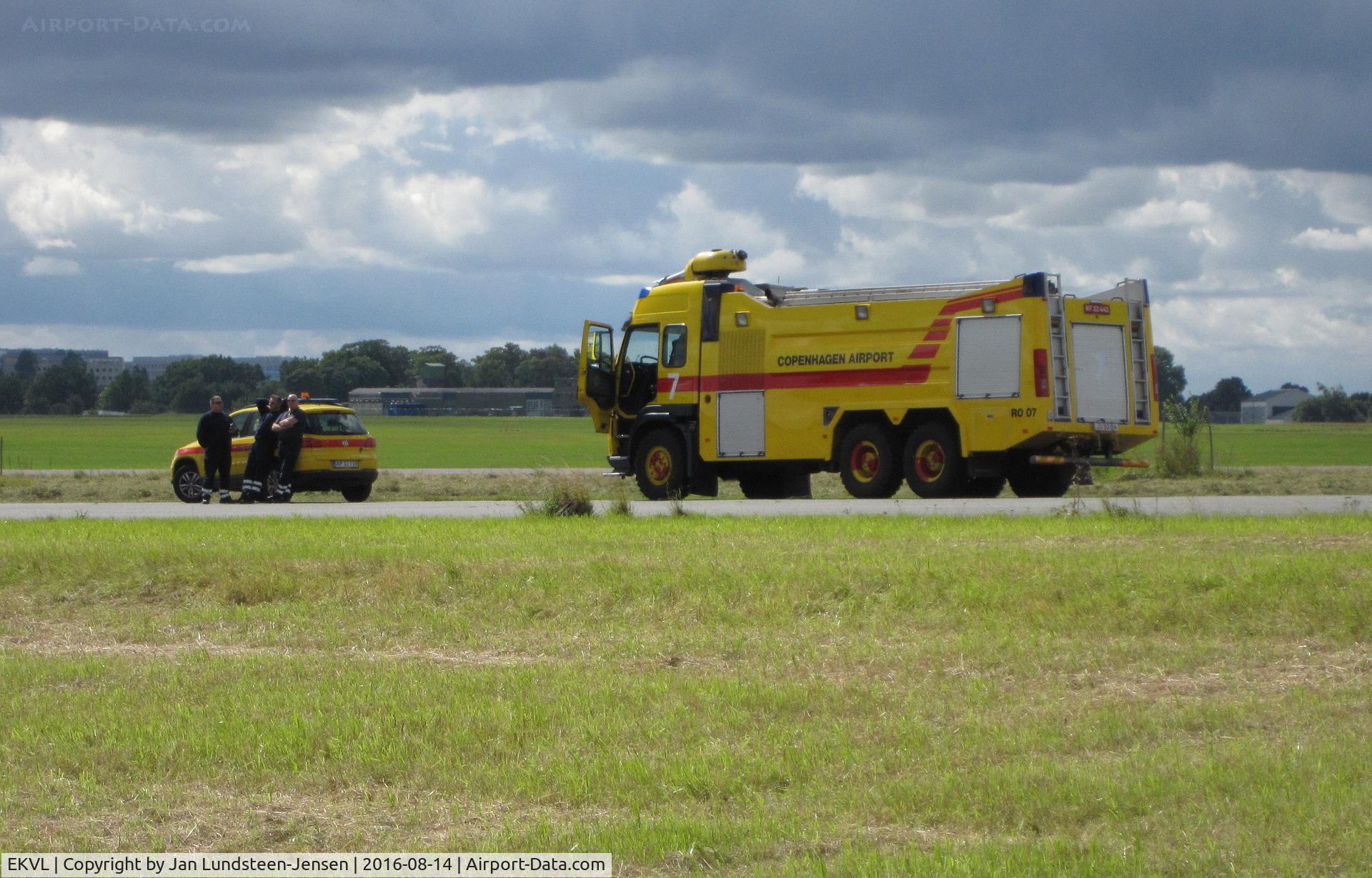 EKVL Airport - Behind the fire chief car is fire truck RO 07 from Copenhagen-Roskilde Airport on standby at an airshow at the former Vaerloese Air Base in Denmark.