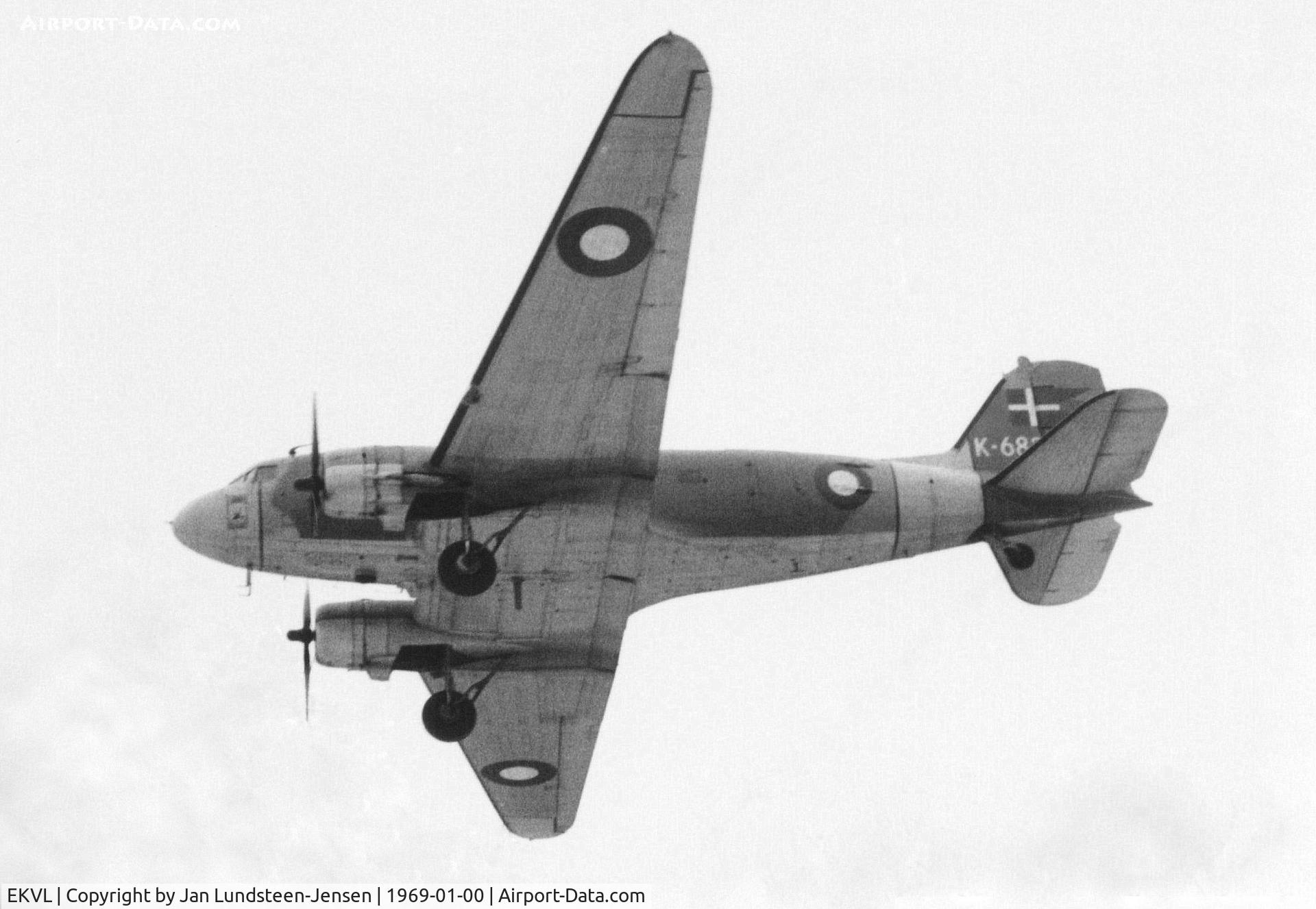 EKVL Airport - Douglas C-47A of Royal Danish Air Force seen on final approach to Runway 28 at Vaerloese Air Base in Denmark in 1969. Snow on ground lights up underside of aircraft.