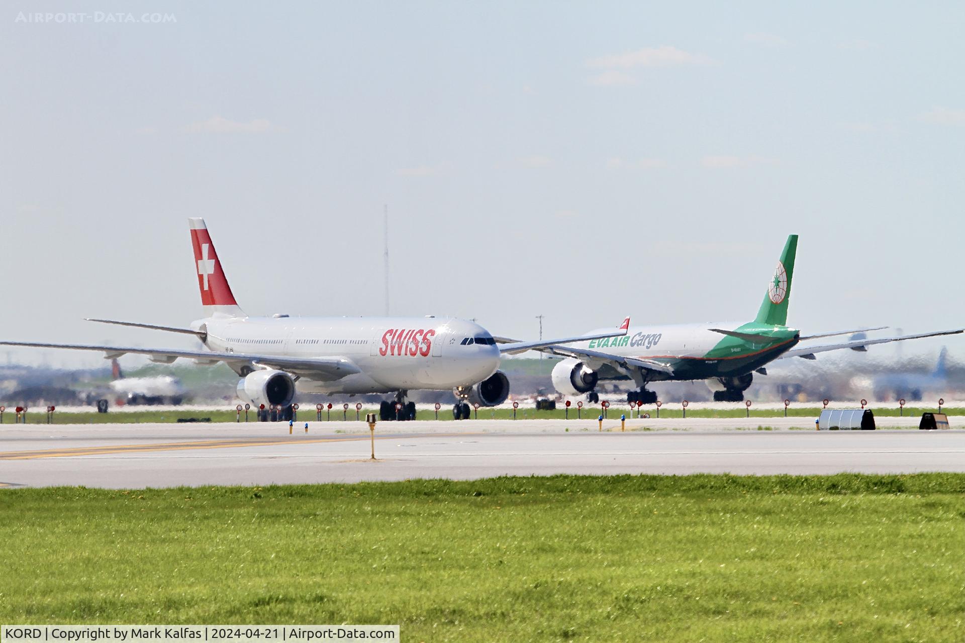 Chicago O'hare International Airport (ORD) - Swiss A333 HB-JHN arriving, Eva Air Cargo B77L B-16787 departing