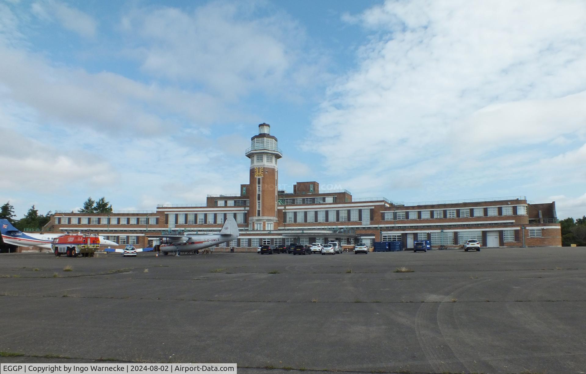 Liverpool John Lennon Airport, Liverpool, England United Kingdom (EGGP) - airside view of the old 1930s terminal and tower (today a Crowne Plaza hotel) with exhibition of vehicles and aircraft preserved by the Speke Aerodrome Heritage Groups (SAHG) on the former apron