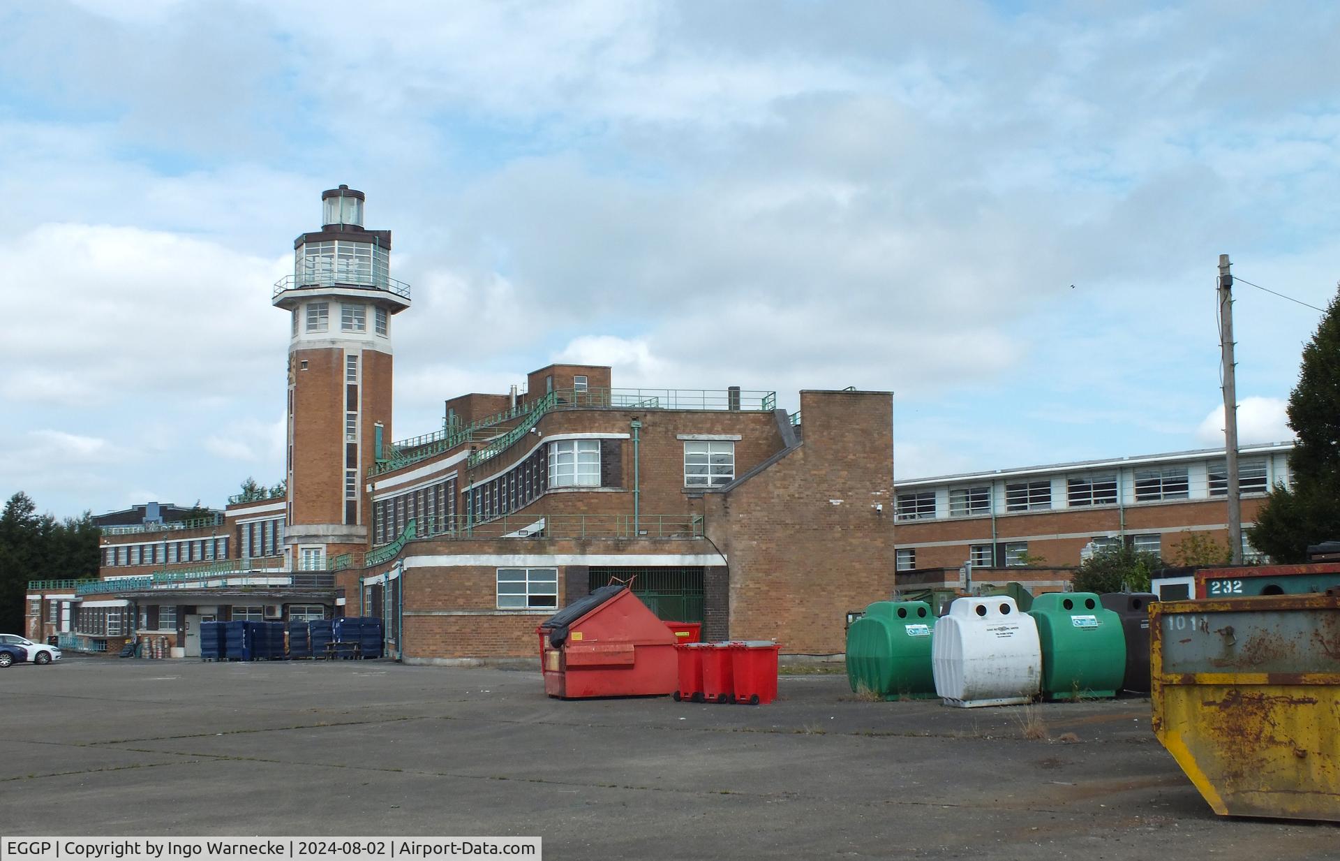 Liverpool John Lennon Airport, Liverpool, England United Kingdom (EGGP) - airside view of the old 1930s terminal and tower (today a Crowne Plaza hotel) with exhibition of vehicles and aircraft preserved by the Speke Aerodrome Heritage Groups (SAHG) on the former apron