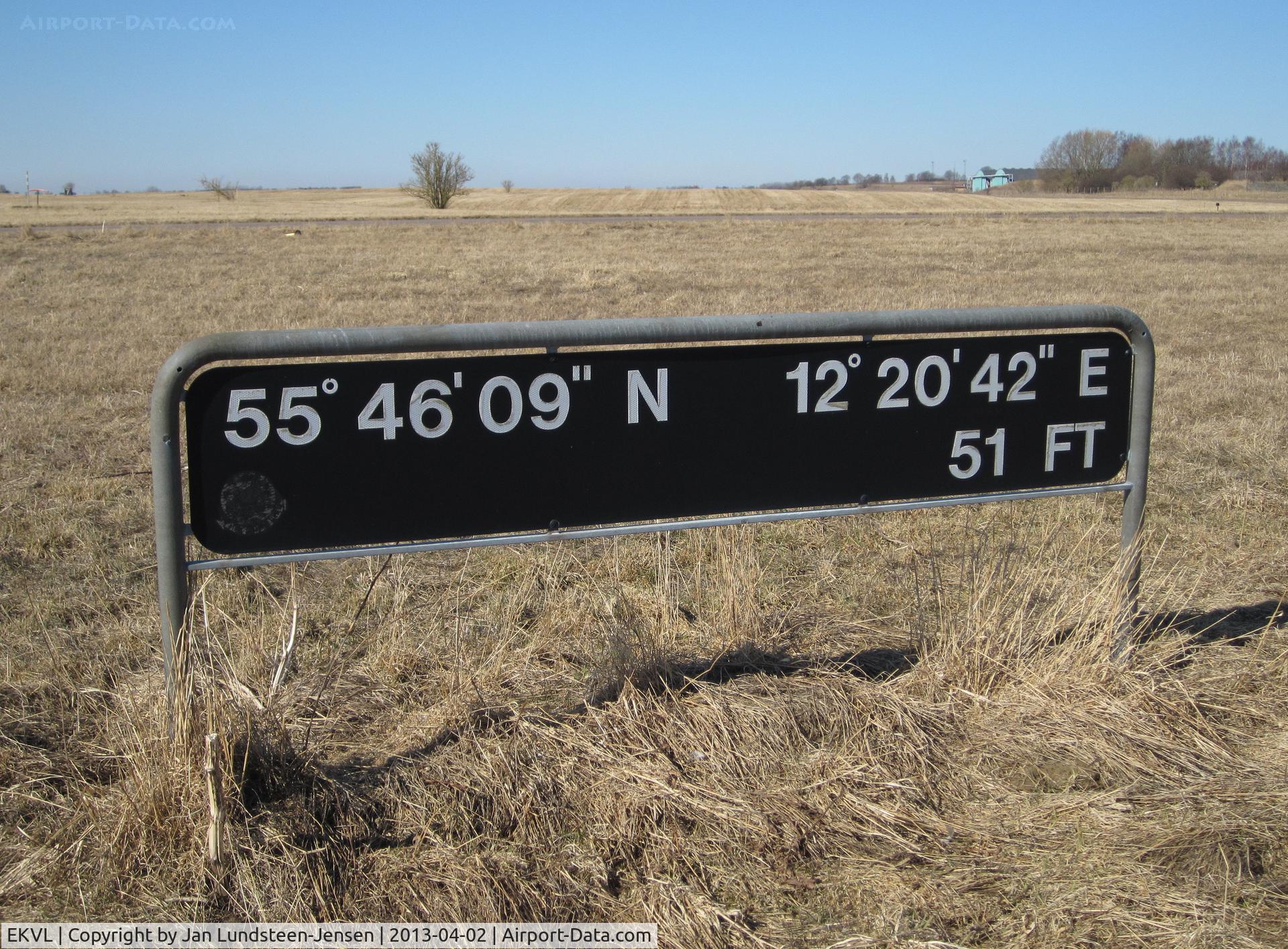 EKVL Airport - Ground Positioning Coordinates and Field Elevation-sign in the eastern part of the closed Vaerloese Air Base in Denmark. The sign was later removed. In the background Taxiway Alpha and Hangar 46.