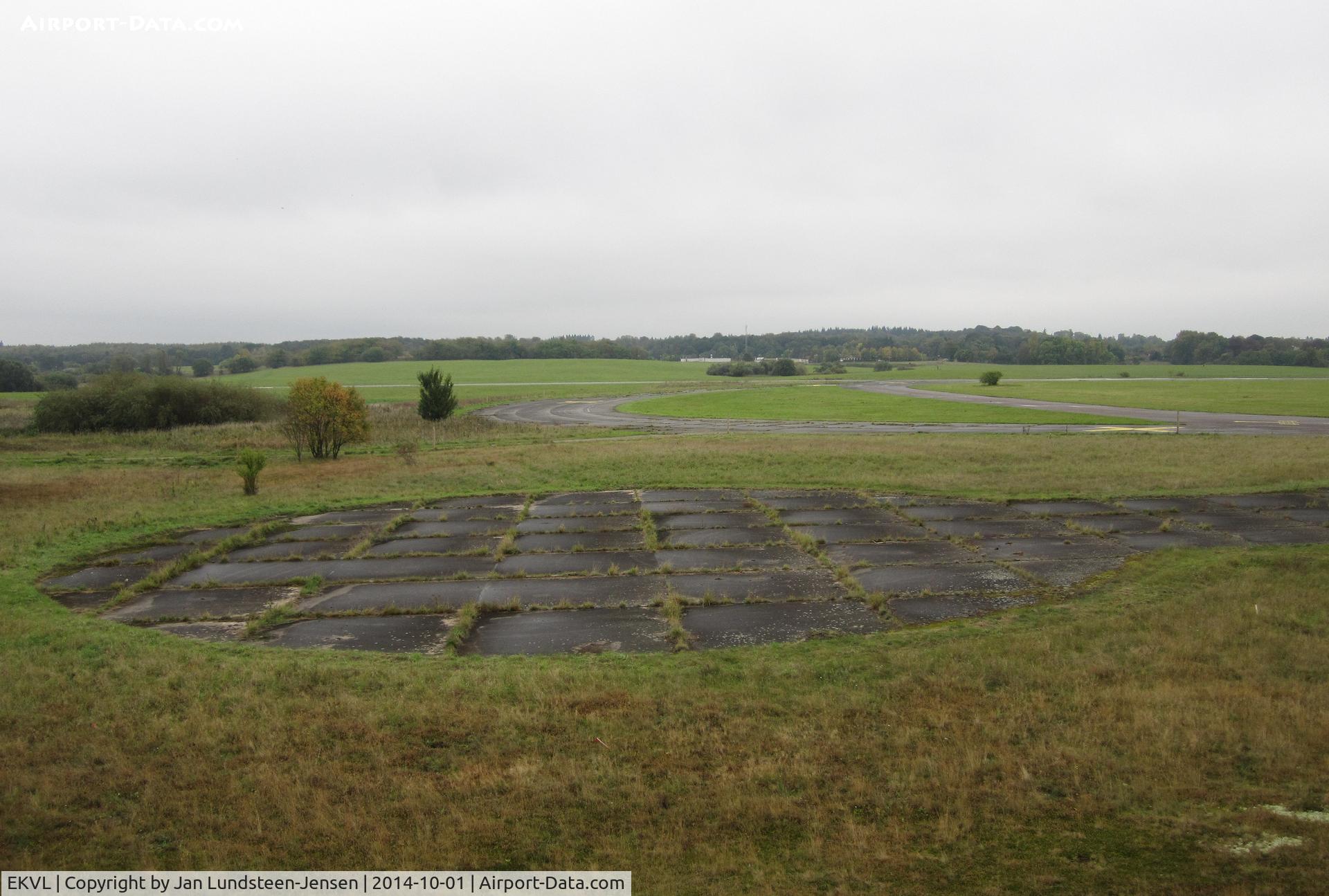 EKVL Airport - The eastern part of the former Vaerloese Air Base in Denmark. In the foreground aircraft parking stand No.01. Curved section behind was used for parking of planes from foreign NATO countries. Runway 28/10 furthest away.