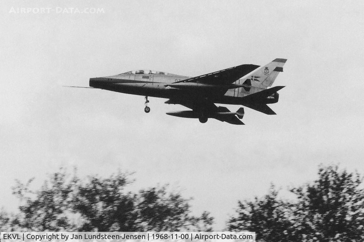 EKVL Airport - North American F-100F Super Sabre of Royal Danish Air Force seen on final approach to Runway 28 at Vaerloese Air Base in Denmark in 1968. The aircraft had a red nose and was one of 24  2-seat F-100s operated by Danish AF 1959-1982.