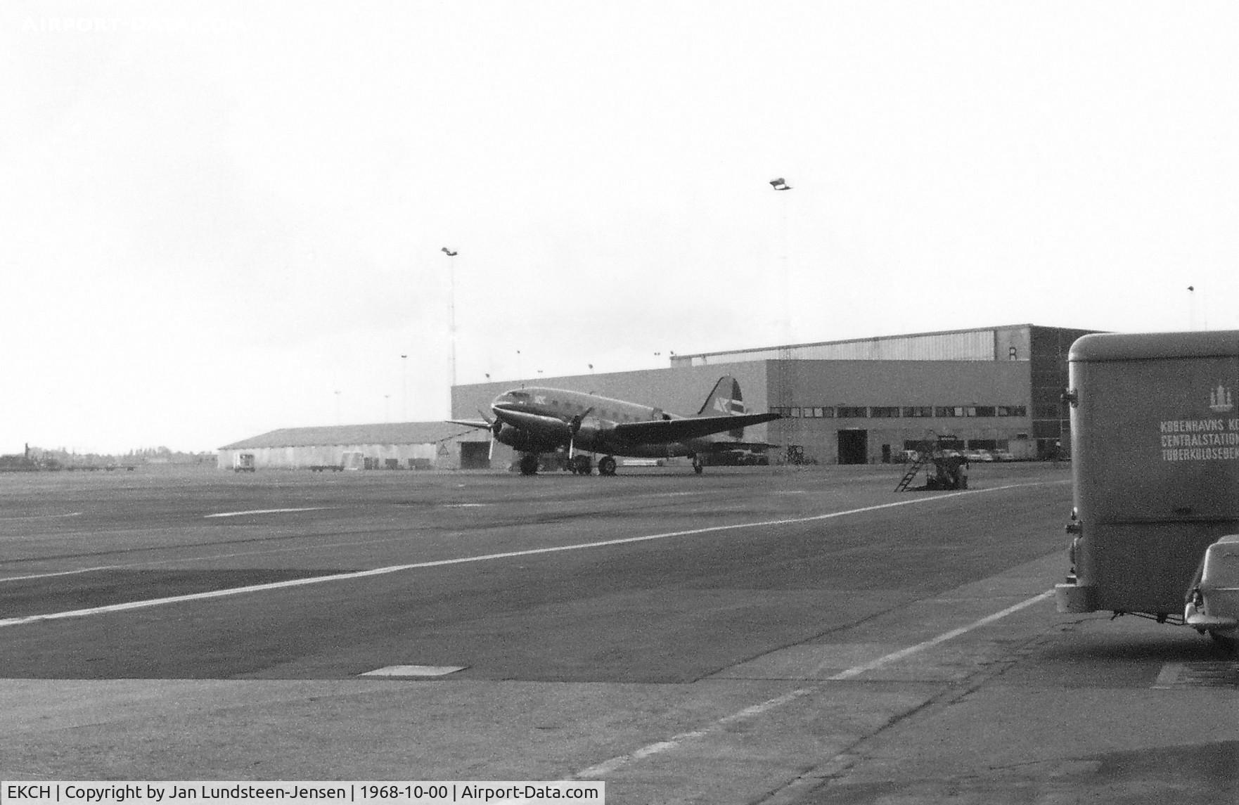 Copenhagen Airport, Kastrup near Copenhagen Denmark (EKCH) - The cargo terminal at Copenhagen-Kastrup Airport in Denmark in 1968 with a Curtiss C-46 of Fred Olsen Airtransport on the apron.