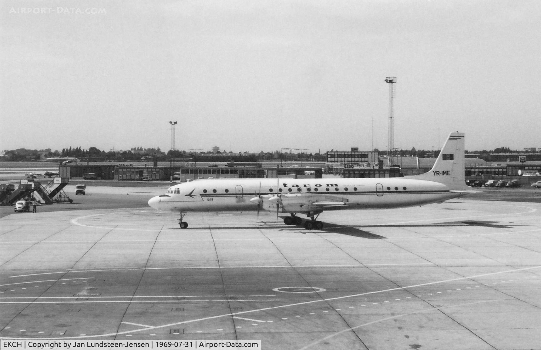 Copenhagen Airport, Kastrup near Copenhagen Denmark (EKCH) - Copenhagen-Kastrup Airport in Denmark in 1969 with an Ilyushin Il-18 of the Romanian airline Tarom being marshalled to the gate. The marshaller beside the Volkswagen 'Follow Me' car seen to the left.
