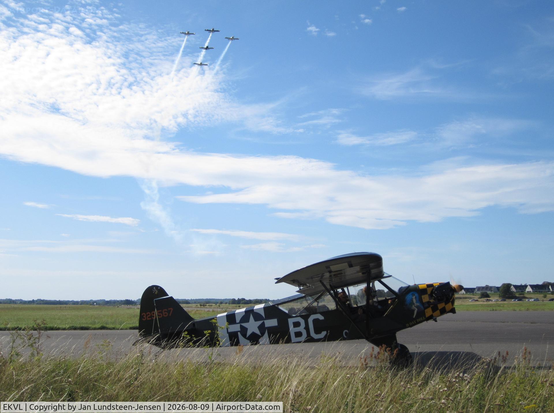 Værløse Air Base Airport, RVators Formation Team in the air and a Piper L-4H on the ground at an airshow at the former Vaerloese Air Base in Denmark., photo by Jan Lundsteen-Jensen